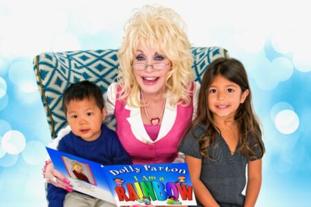Dolly Parton with two kids who receive books through Imagination Library