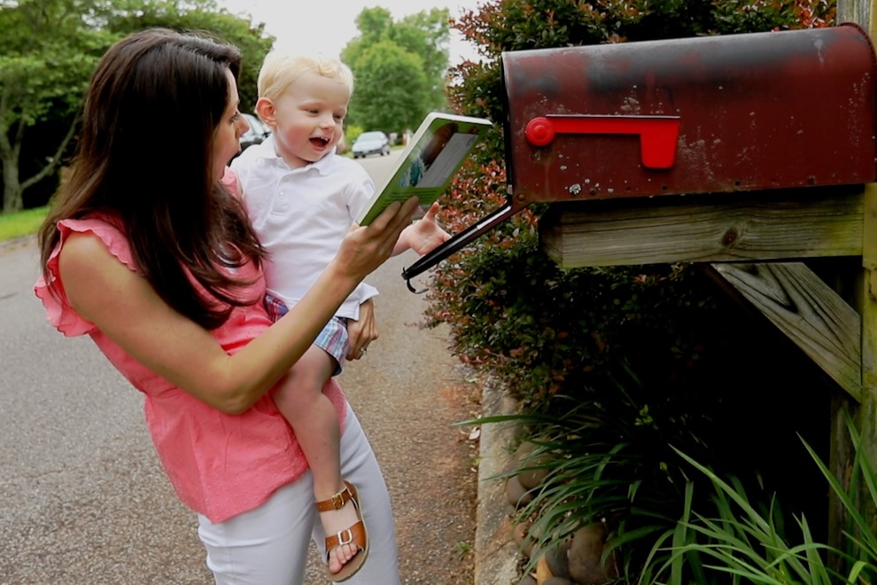 Mom and preschooler checking mailbox for a book from Imagination Library