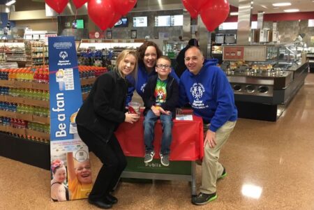 family at Publix during Light the Torch campaign with special Olympics
