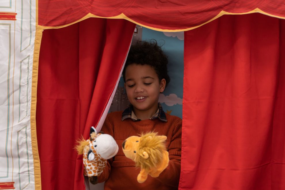 little boy playing puppets