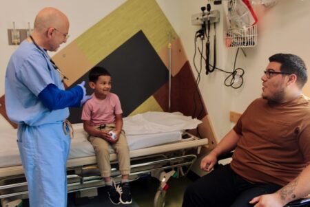 Doc, child, and parent at KidMed – Flanzenbaum