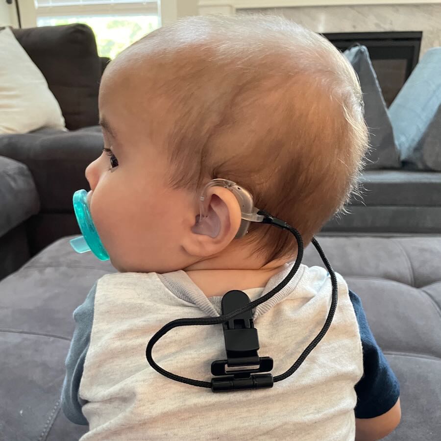 baby with hearing gear