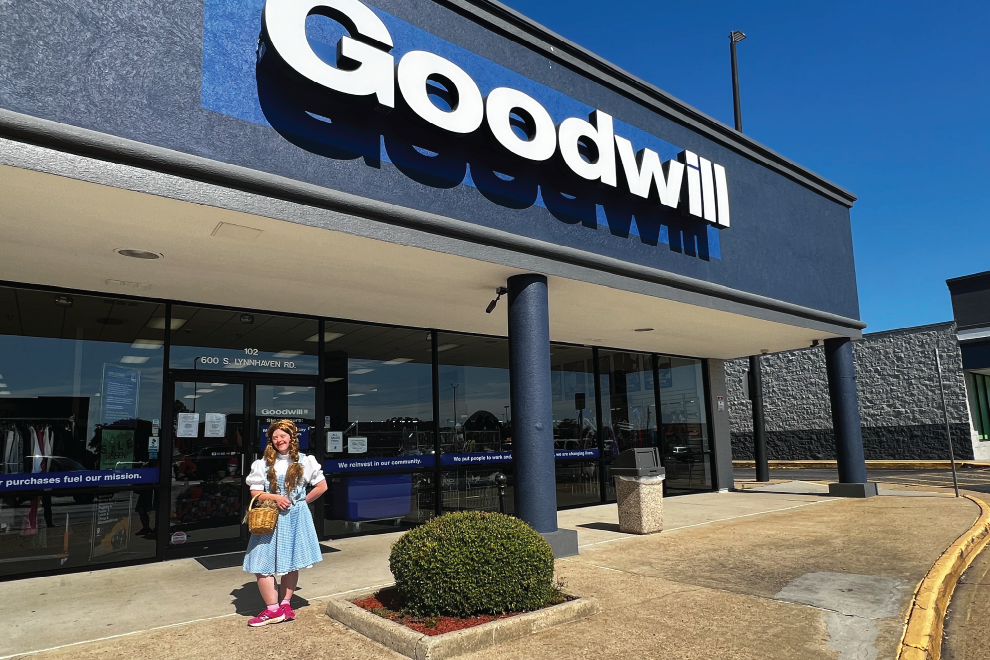 girl in halloween costume in front of Goodwill