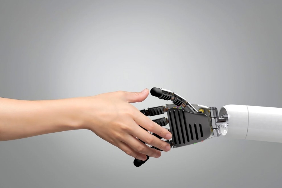 robot hand shaking human hand