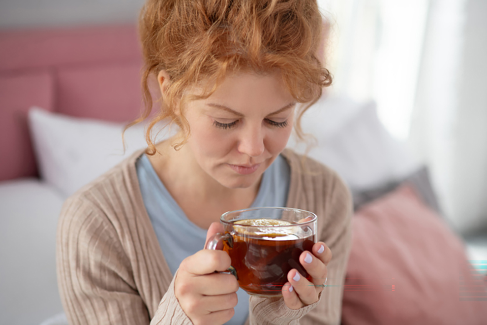 6 Essential Things to Help with Morning Sickness A pregnant woman drinking ginger tea