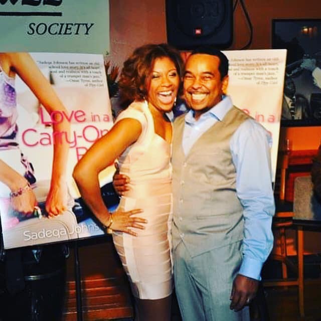 Author Sadeqa Johnson with her husband at the book launch for her first book, Love in a Carry-On Bag