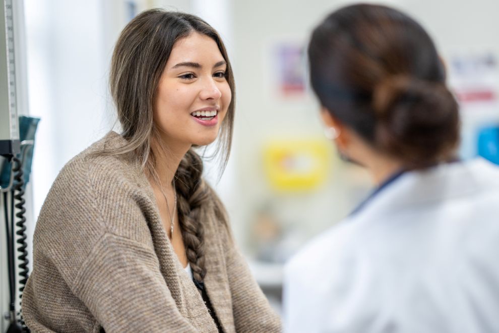 A woman speaks to her gynecologist about STI treatment options