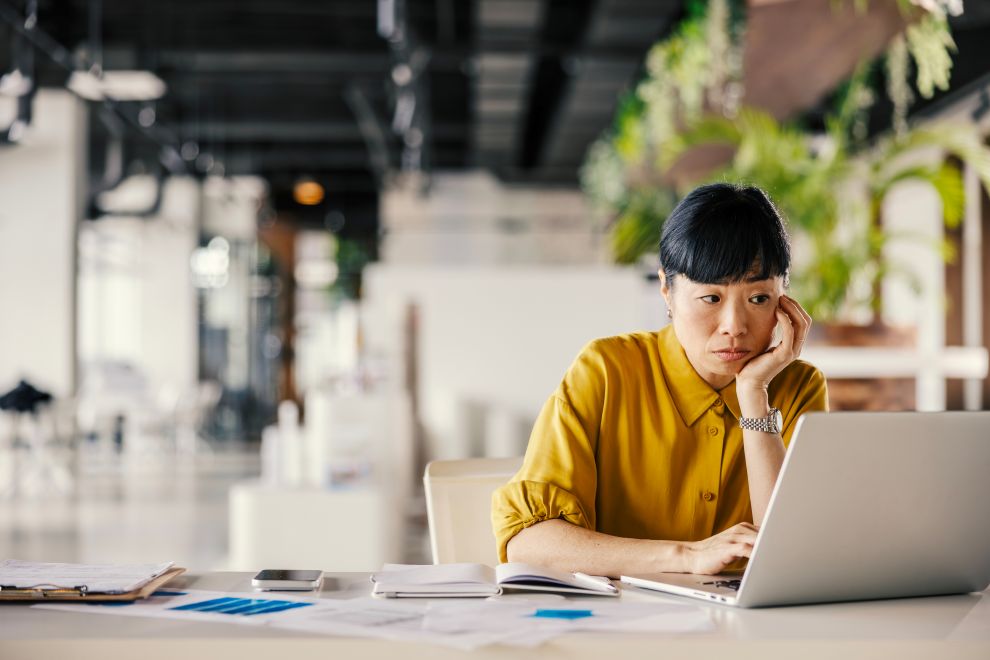A middle aged businesswoman experiences perimenopause brain fog at work