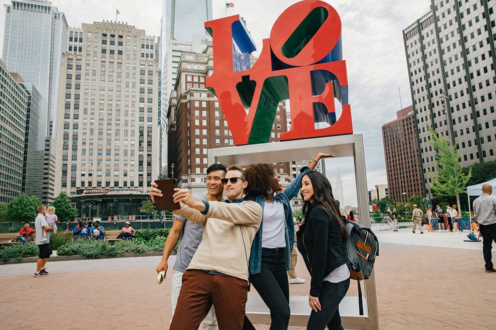 group of friends at the love sign in downtown Philadelphia PA