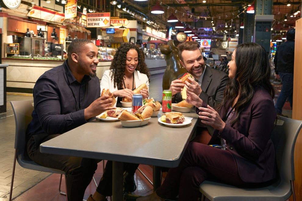 Four people eating lunch at Reading Terminal Market in Philadelphia