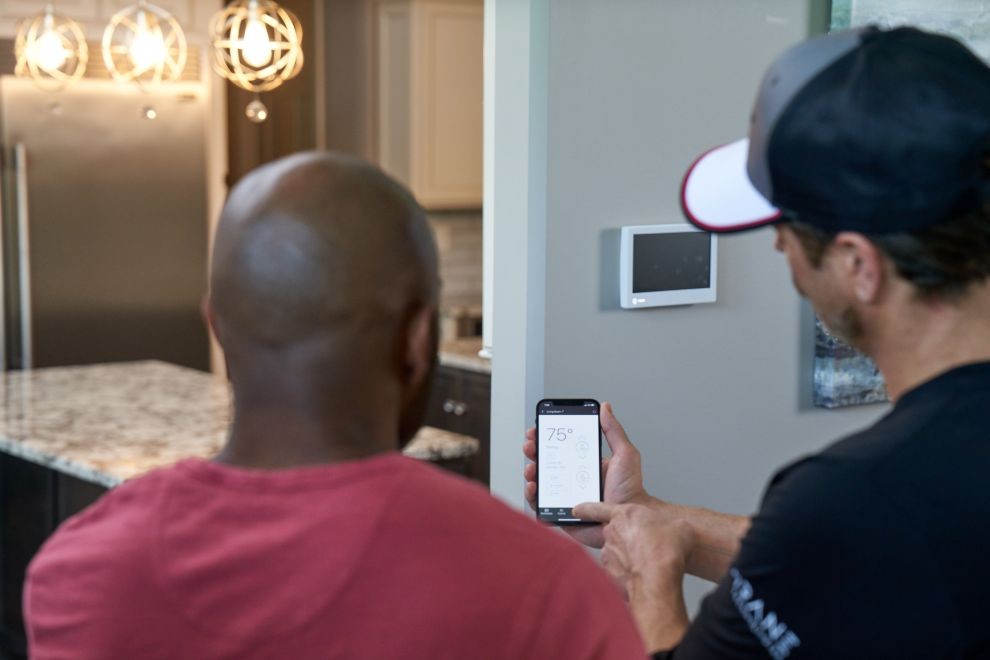 Trane dealer displaying thermostat on phone