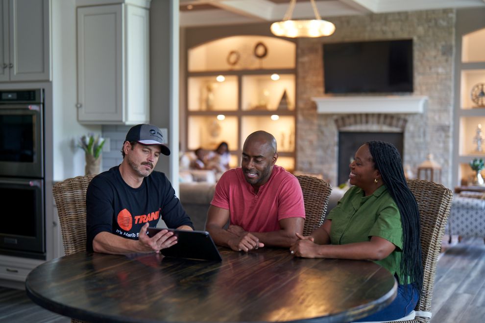 Trane dealer showing iPad to two customers