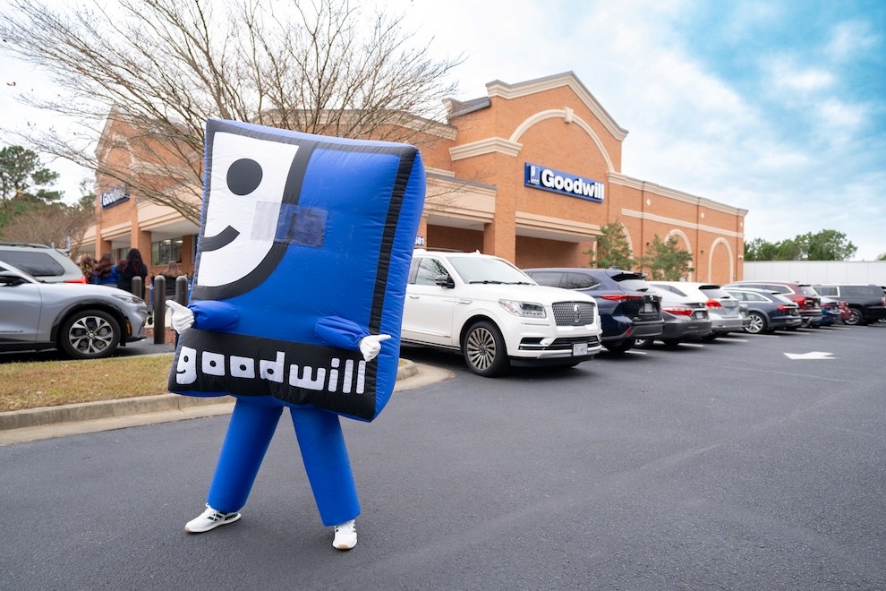 Goodwill mascot in front of a Goodwill store