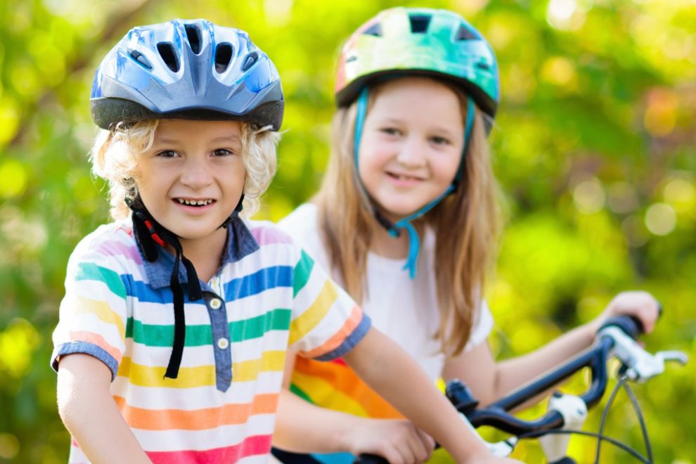 AAA Urges Summer Bike Safety and E-Bike Awareness Two kids on bikes with helmets (from AAA)