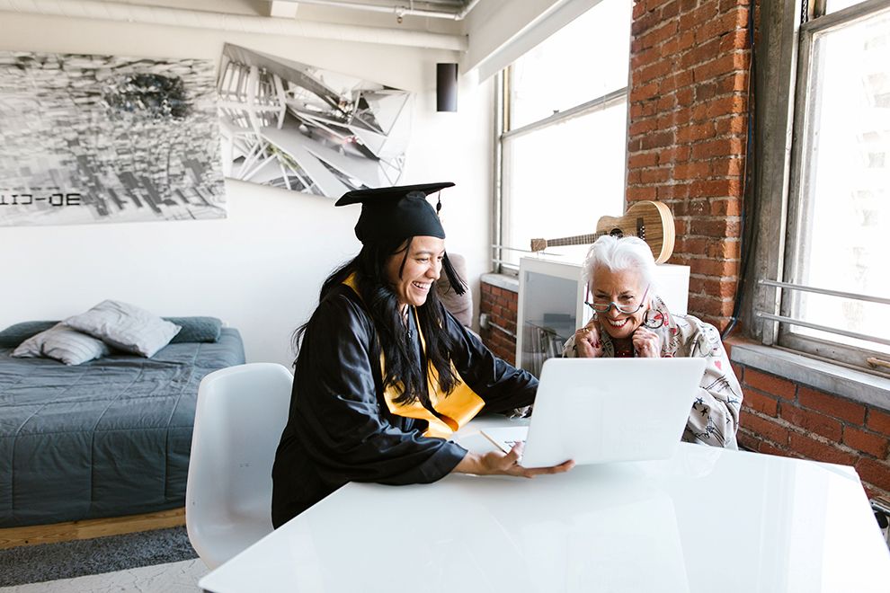 A Lesson in Saving a graduate and an older lady, presumably a relative, looking happily at a computer screen
