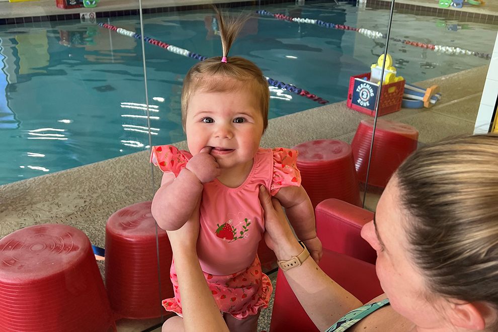 Testing the Waters baby at an indoor swimming pool