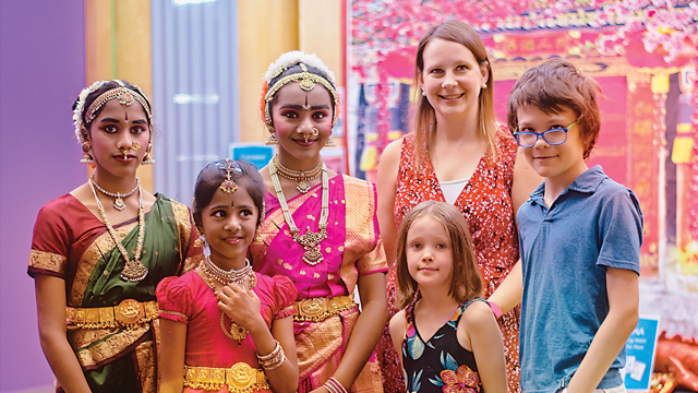 Family with Indian dancers at Children's Museum cultural event