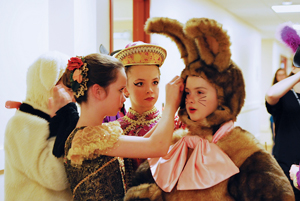 School of Richmond Ballet students apply finishing touches as they prepare to take the stage as Dolls in the Battle scene of The Nutcracker.
