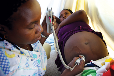 A pregnant woman receives prenatal care from a skilled birth attendant at a mobile health clinic in Haiti.