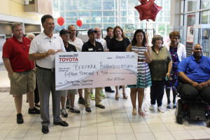 Breonna Hughes, with family and friends, accepts the Saving Lives, Supporting Futures Scholarship from representatives of McGeorge Toyota and Drive Smart Virginia. 